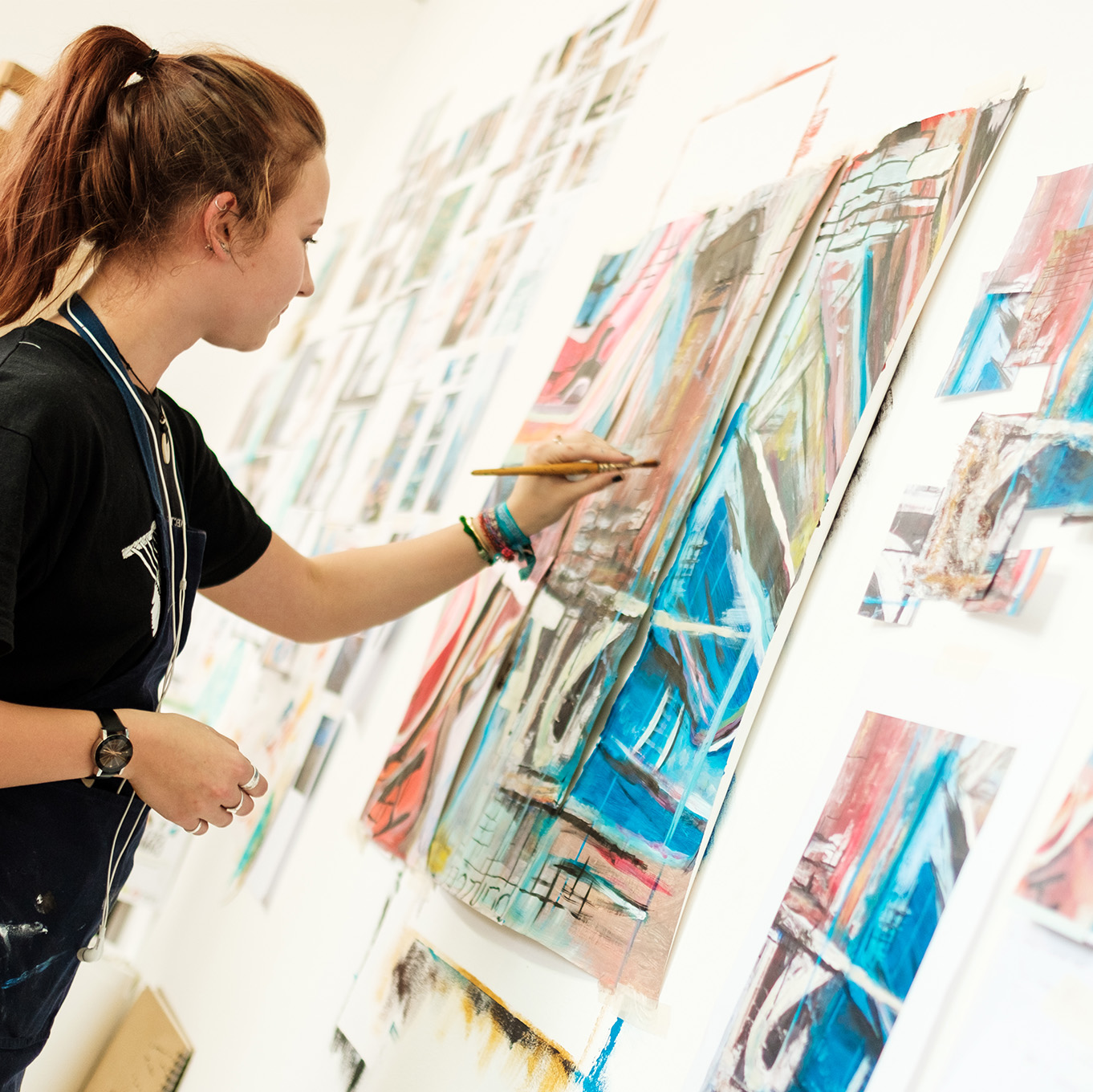 A fine art student paints the finishing touches onto her work