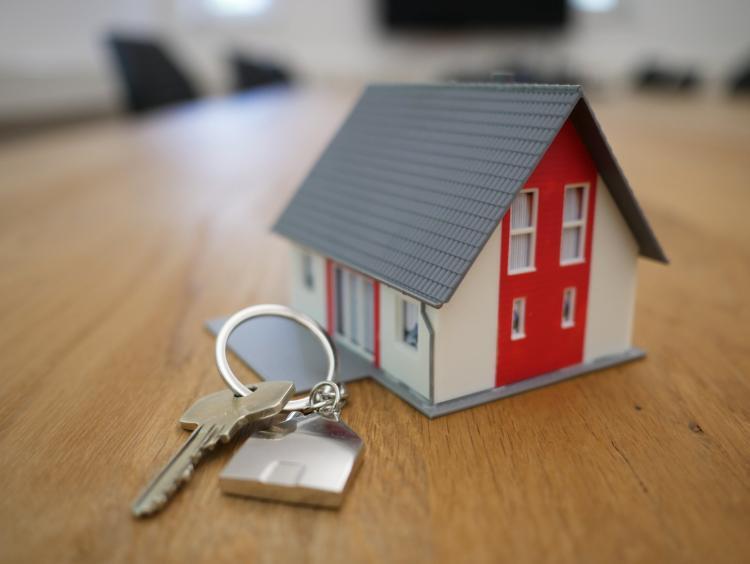 A mini wooden house on a set of keys