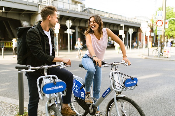 2 people on bikes smiling